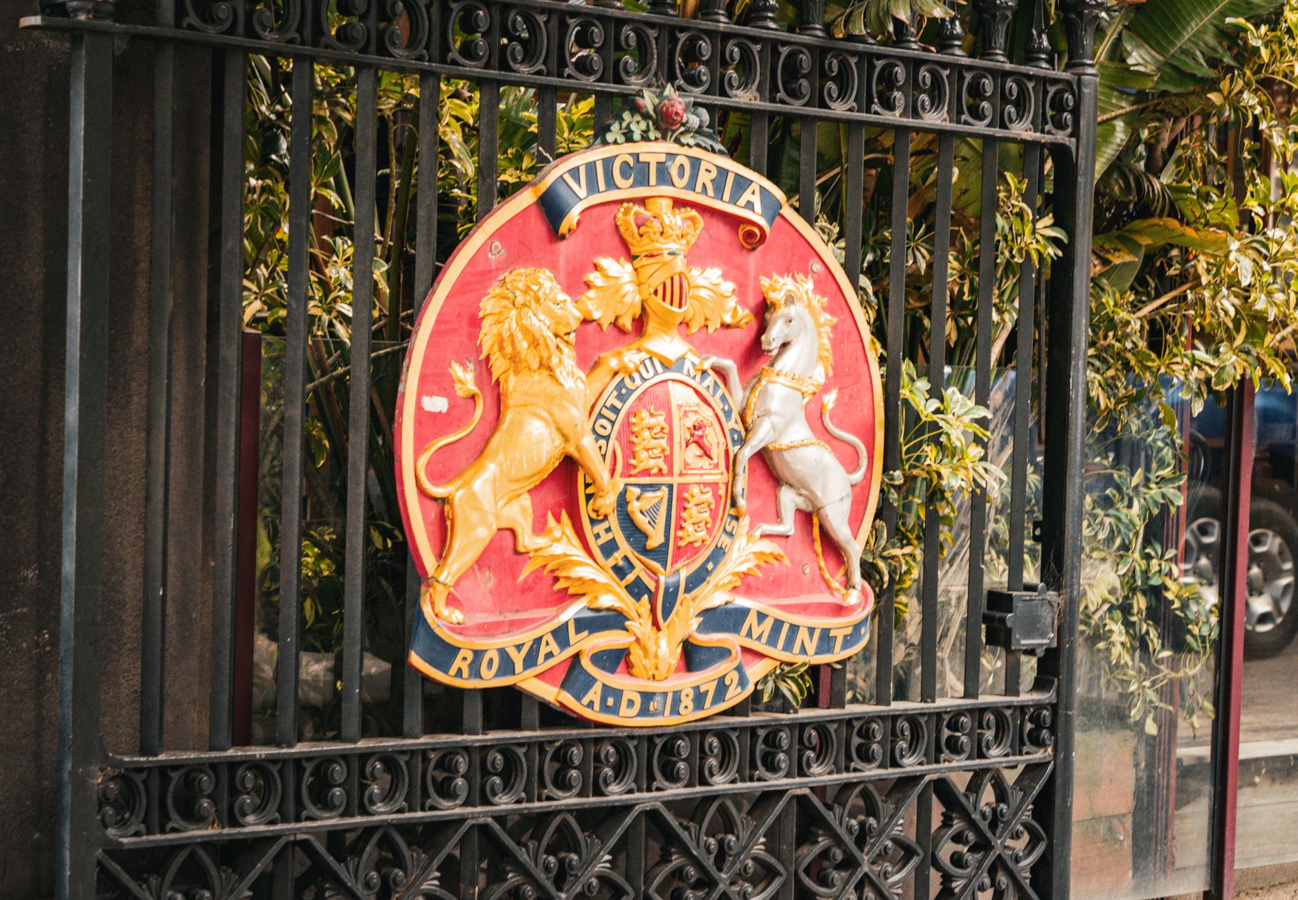Colorful Royal Mint Victoria emblem on gate highlights Melbourne's heritage