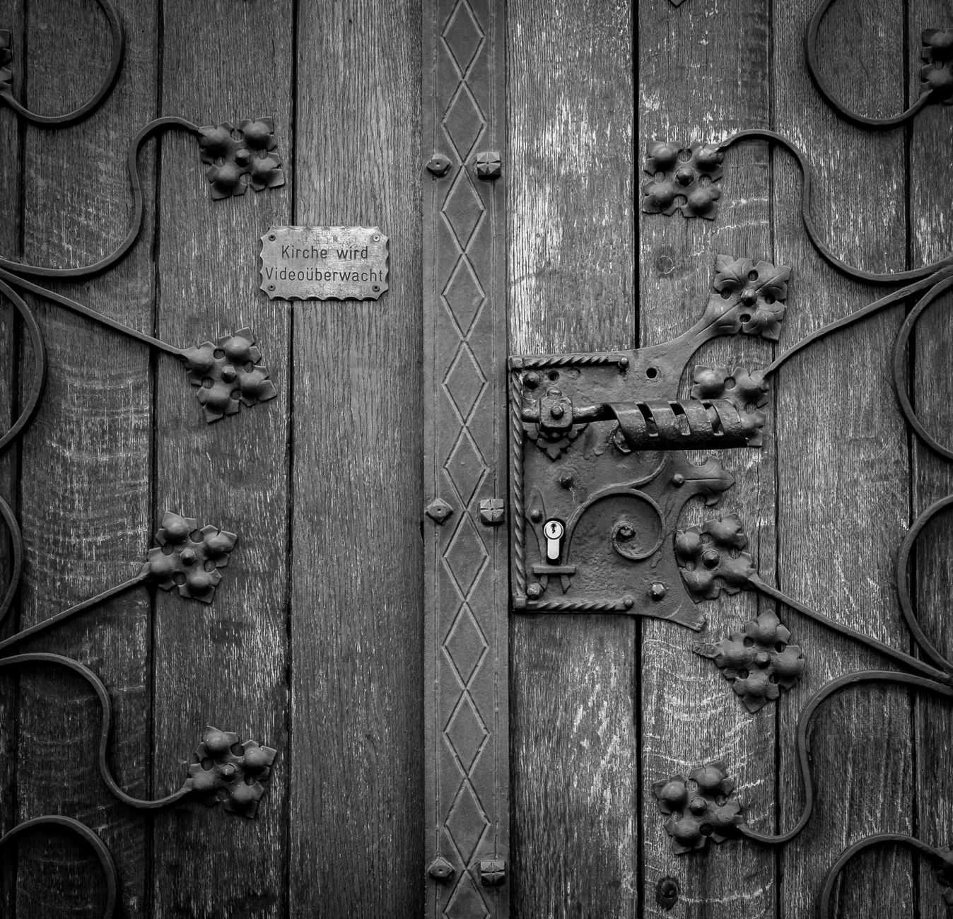 Intricate black and white design of a vintage wooden church door in Mönchengladbach
